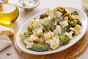 Roasted cauliflower and broccoli on a serving plate, healthy vegetable side dish