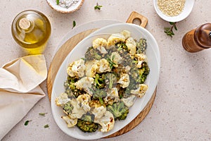 Roasted cauliflower and broccoli on a serving plate, healthy vegetable side dish