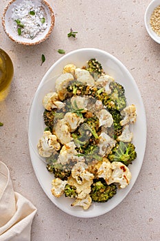 Roasted cauliflower and broccoli on a serving plate, healthy vegetable side dish