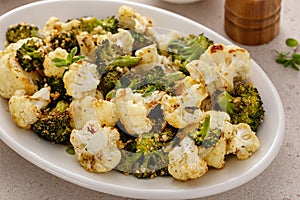 Roasted cauliflower and broccoli on a serving plate, healthy vegetable side dish