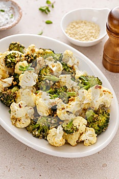 Roasted cauliflower and broccoli on a serving plate, healthy vegetable side dish