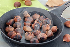 Roasted chestnuts in black pan