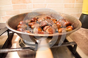 Roasted chestnuts cooking on a pan