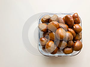 Roasted chestnuts served in a glass dish