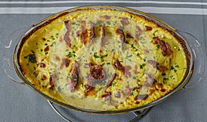 Roasted chicken breast and bacon with cream sauce and parsley