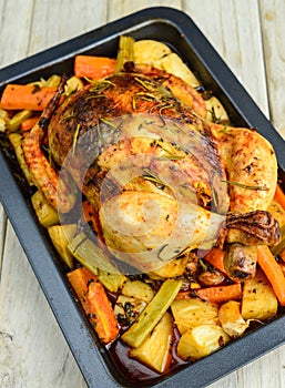 Roasted chicken with herbs and roots vegetables