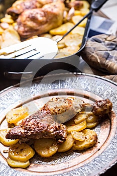 Roasted chicken leg with potatoes with caraway and garlic