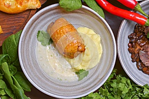 Roasted chicken with mashes potatoes served in a bowl with fresh organic greenery - dill, spinach, parsley.