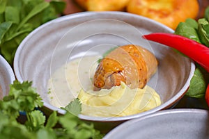 Roasted chicken with mashes potatoes served in a bowl with fresh organic greenery - dill, spinach, parsley.