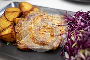 Roasted chicken meat with potatoes and coleslaw