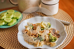 Roasted chicken mushroom pepper pasta in a white plate. toning. selective focus