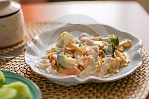 Roasted chicken mushroom pepper pasta in a white plate. toning. selective focus