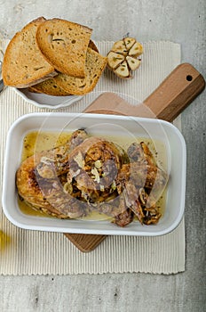 Roasted chicken parts with bio garlic, herb-garlic toast