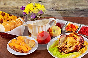 Roasted chicken. Thanksgiving table served with , decorated bright autumn leaves and candles. ,