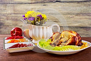 Roasted chicken. Thanksgiving table served with , decorated bright autumn leaves and candles. ,
