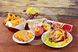 Roasted chicken. Thanksgiving table served with , decorated bright autumn leaves and candles. ,