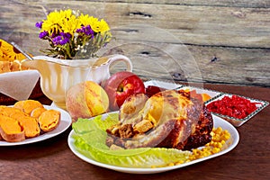 Roasted chicken. Thanksgiving table served with , decorated bright autumn leaves and candles. ,