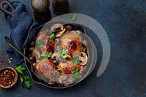 Roasted  chicken thighs with mushrooms on cast iron  pan