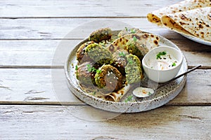 Roasted chickpeas falafel patties on grunge clay plate close up