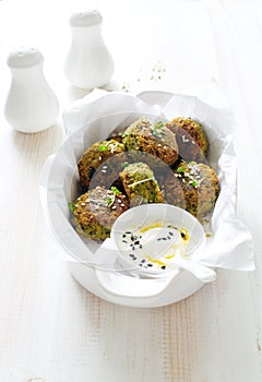 Roasted chickpeas falafel patties in white cooking tray close up