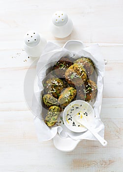 Roasted chickpeas falafel patties in white tray on white wooden background