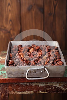 roasted cocoa chocolate beans in Vintage heavy cast aluminum roasting pan