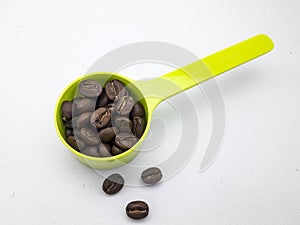 Roasted coffe bean in plastic spoon