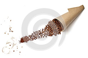 Roasted coffee beans in a bag made of craft paper, poured onto a white background and ground into powder. Top view