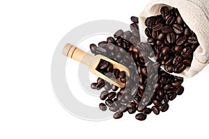 Roasted coffee beans in bag with old scoop isolated on white background.
