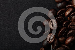 Roasted coffee beans on the black background for wallpaper or decor