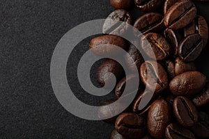 Roasted coffee beans on the black background for wallpaper or decor