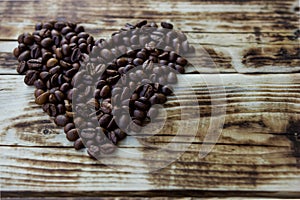 Roasted coffee beans on a brown wooden table