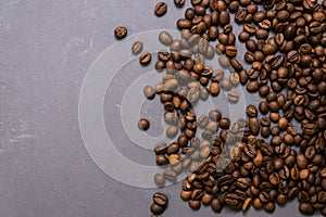 Roasted coffee beans in bulk on a gray concrete background. dark cofee roasted grain flavor aroma cafe, natural coffe shop