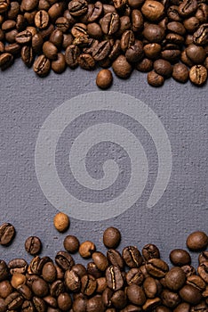 Roasted coffee beans in bulk on a gray concrete background. dark cofee roasted grain flavor aroma cafe, natural coffe shop