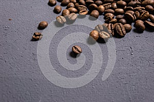 Roasted coffee beans in bulk on a gray concrete background. dark cofee roasted grain flavor aroma cafe, natural coffe shop