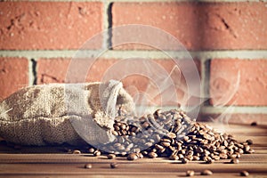 Roasted coffee beans in burlap sack