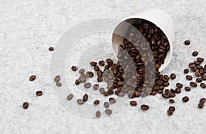 Roasted coffee beans in a caffe mug