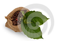 Roasted coffee beans and cherry with flower and green leaf in sack bag isolated on white background with clipping path,top view