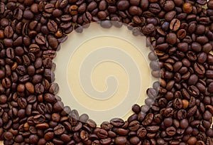 Roasted coffee beans with circle copy space in the middle. Aroma drink concept.