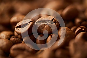 Roasted coffee beans close up. Espresso dark, aroma, black caffeine drink.