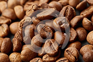 Roasted coffee beans close up. Espresso dark, aroma, black caffeine drink.