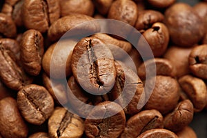 Roasted coffee beans close up. Espresso dark, aroma, black caffeine drink.