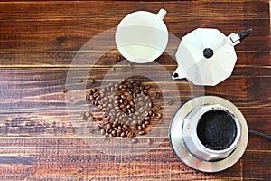 Roasted coffee beans with coffee mocka pot on retro wood floor
