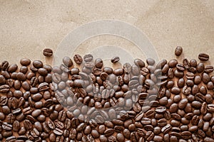 Roasted coffee beans on crumple brown paper background