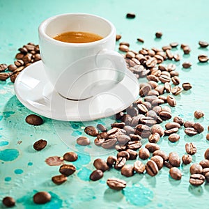 Roasted coffee beans and cup of hot espresso