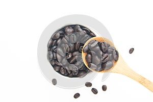 Roasted coffee beans in cup and on spoon isolated on white background, Top view, Selective focus