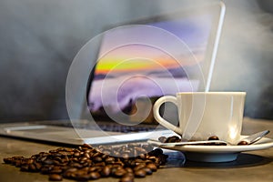 Roasted coffee beans and espresso in a cup of hot coffee with hot steam and smoke, black background,workplace in a cafe shop,a cup