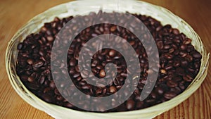 Roasted coffee beans fall into a bawl