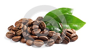 Roasted coffee beans and fresh green leaves on white