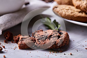 Roasted coffee beans get out of overturned glass jar on homespun tablecloth, selective focus, side view